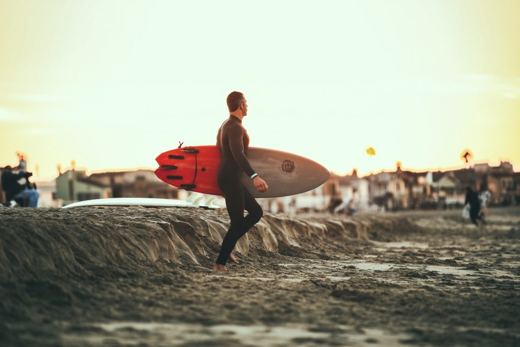 Surfer carrying surfboard