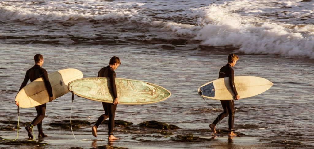 Three Surfers